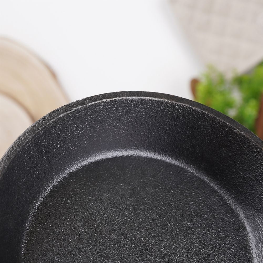 Cast iron dish with wooden tray for tapas and snacks