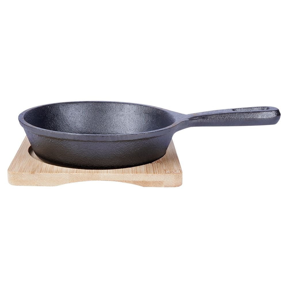 Cast iron dish with wooden tray for tapas and snacks