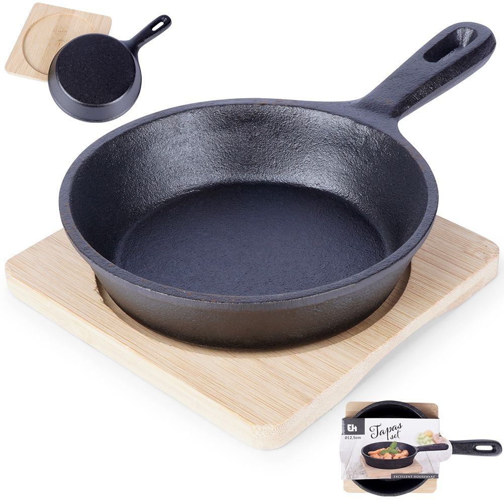 Cast iron dish with wooden tray for tapas and snacks