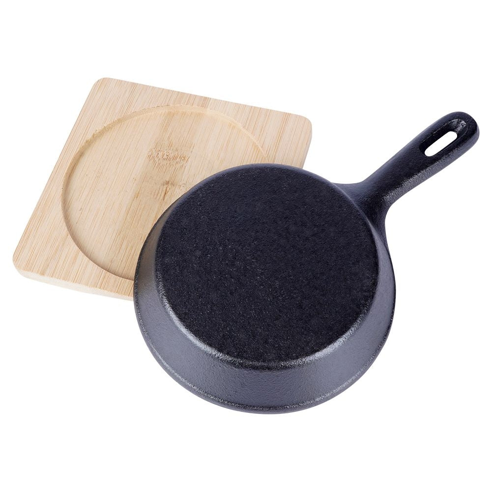 Cast iron dish with wooden tray for tapas and snacks