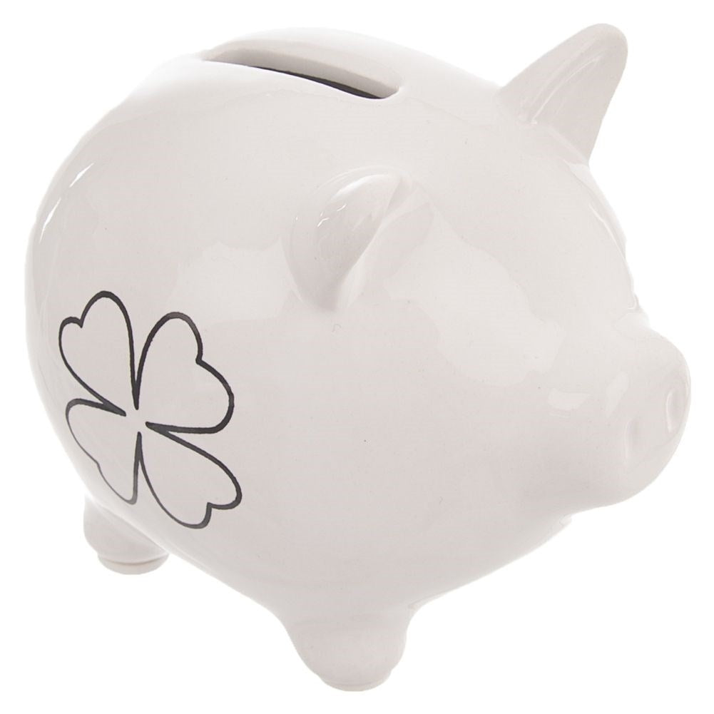 Ceramic piggy bank with clover motif, perfect for saving.