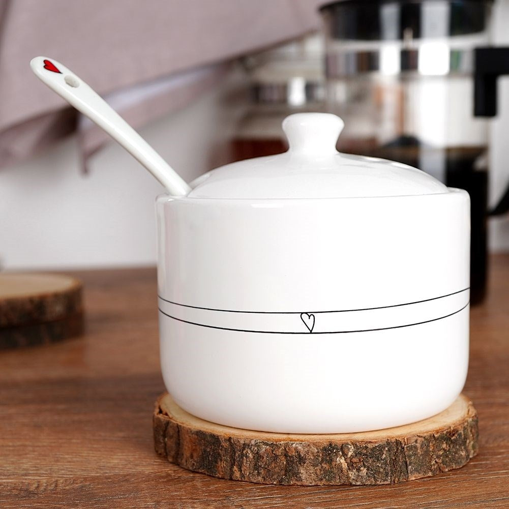 Ceramic sugar bowl with lid and spoon, elegant table decoration