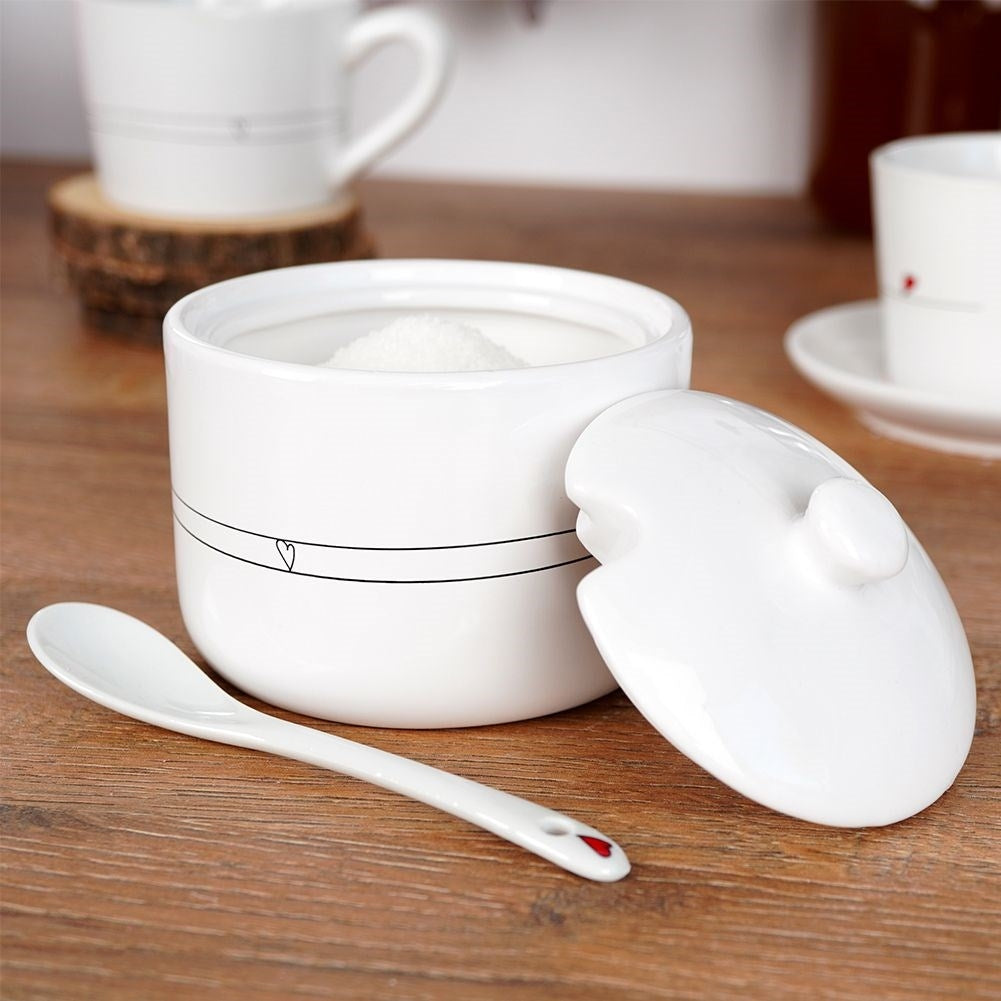 Ceramic sugar bowl with lid and spoon, elegant table decoration
