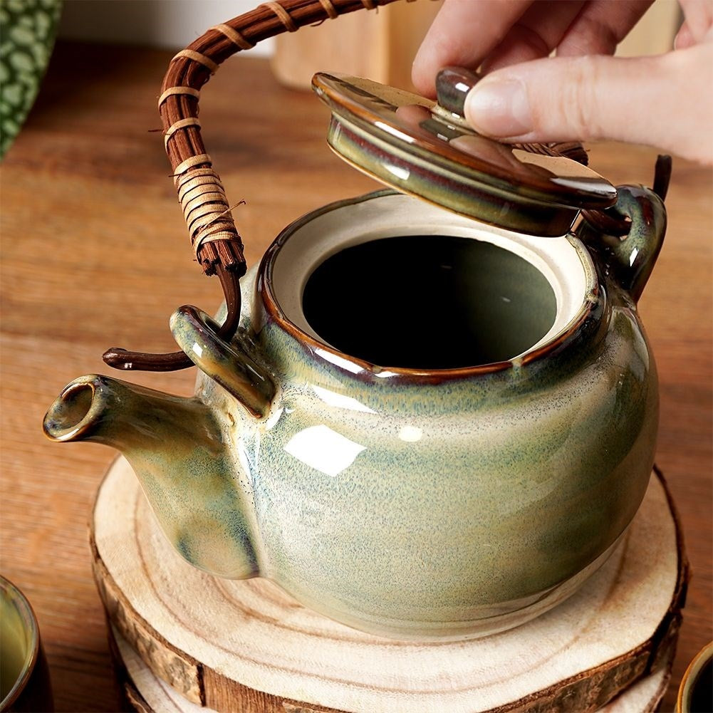 Ceramic teapot with four bowl-shaped cups