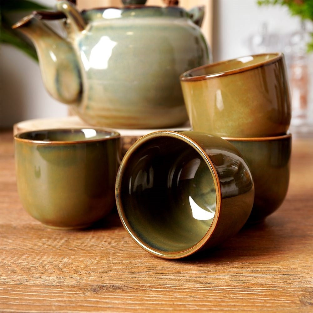 Ceramic teapot with four bowl-shaped cups