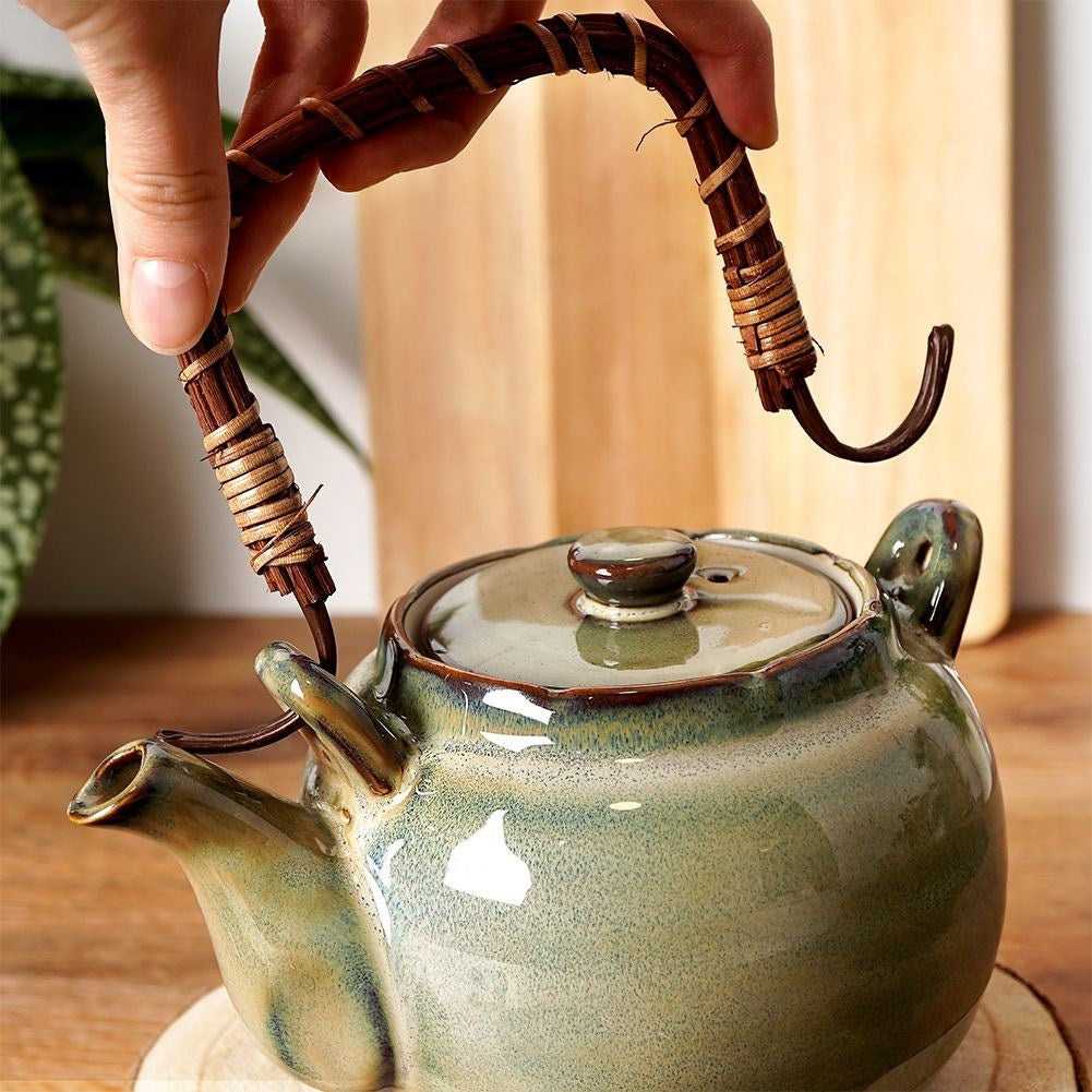 Ceramic teapot with four bowl-shaped cups