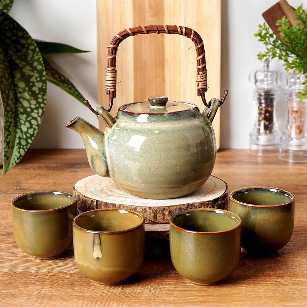 Ceramic teapot with four bowl-shaped cups