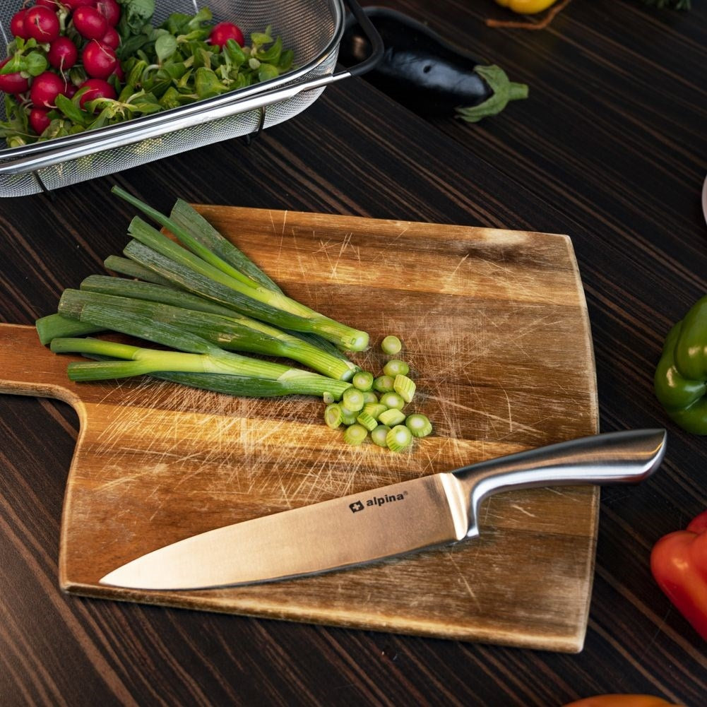Chef's knife in stainless steel with serrated blade