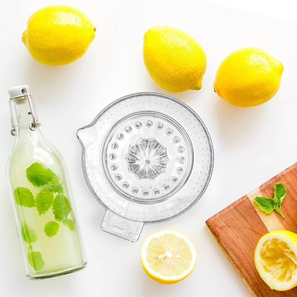 Citrus press with handle and spout for easy juicing