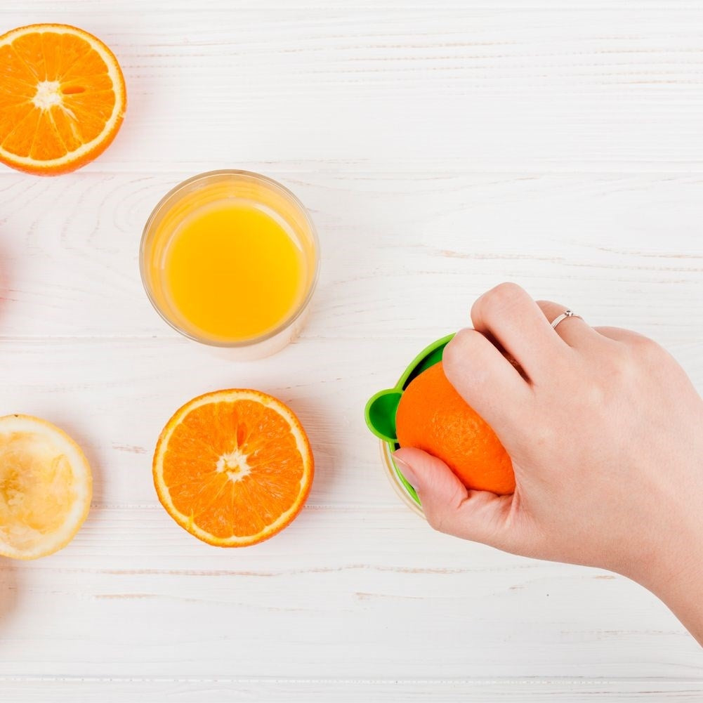 Citrus press with spout and glass container for fresh juice