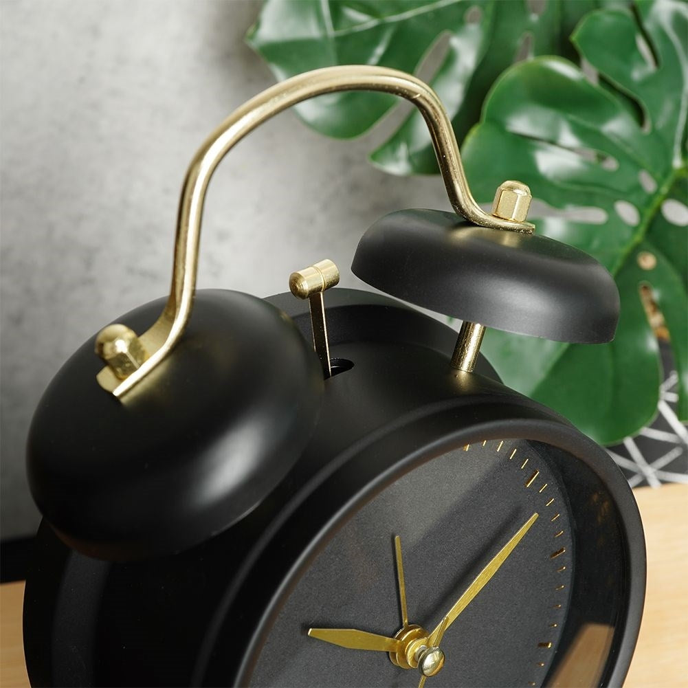 Classic black table clock with alarm and gold details
