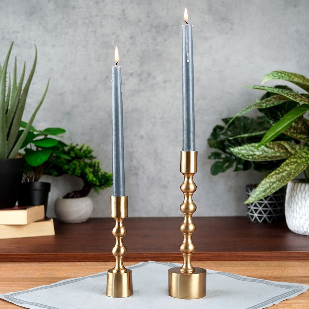 Classic candle holder in aluminum with a golden hue