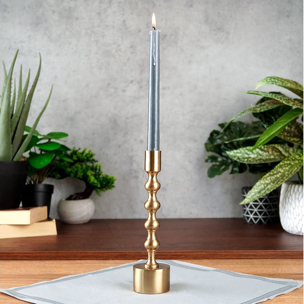Classic candle holder in aluminum with a golden hue