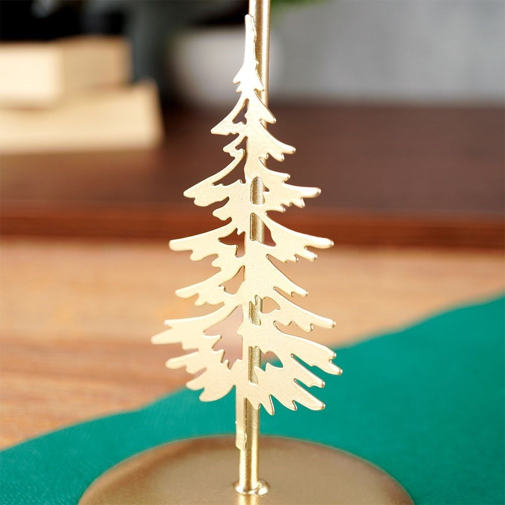 Classic golden candlestick with decorative metal fir tree