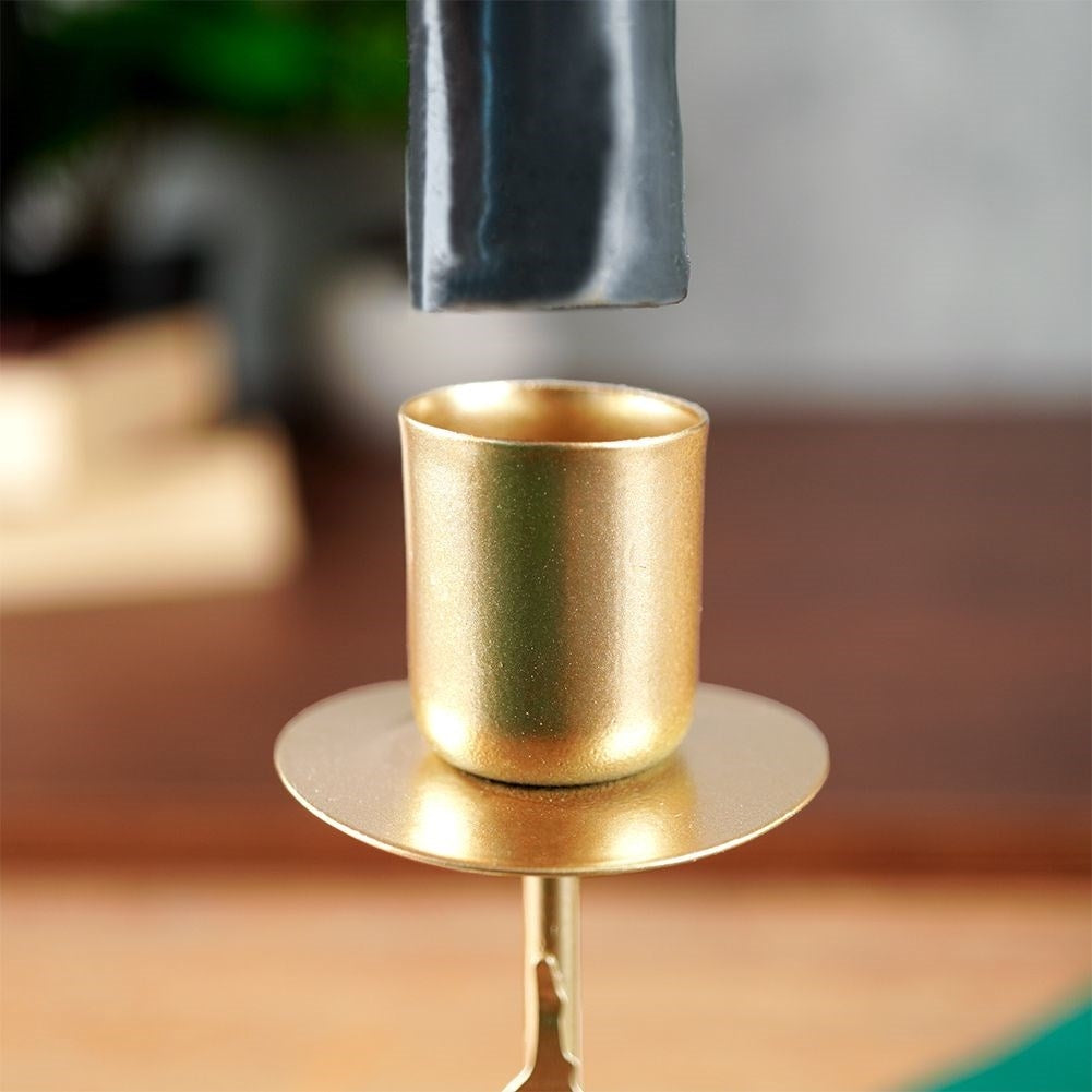 Classic golden candlestick with decorative metal fir tree