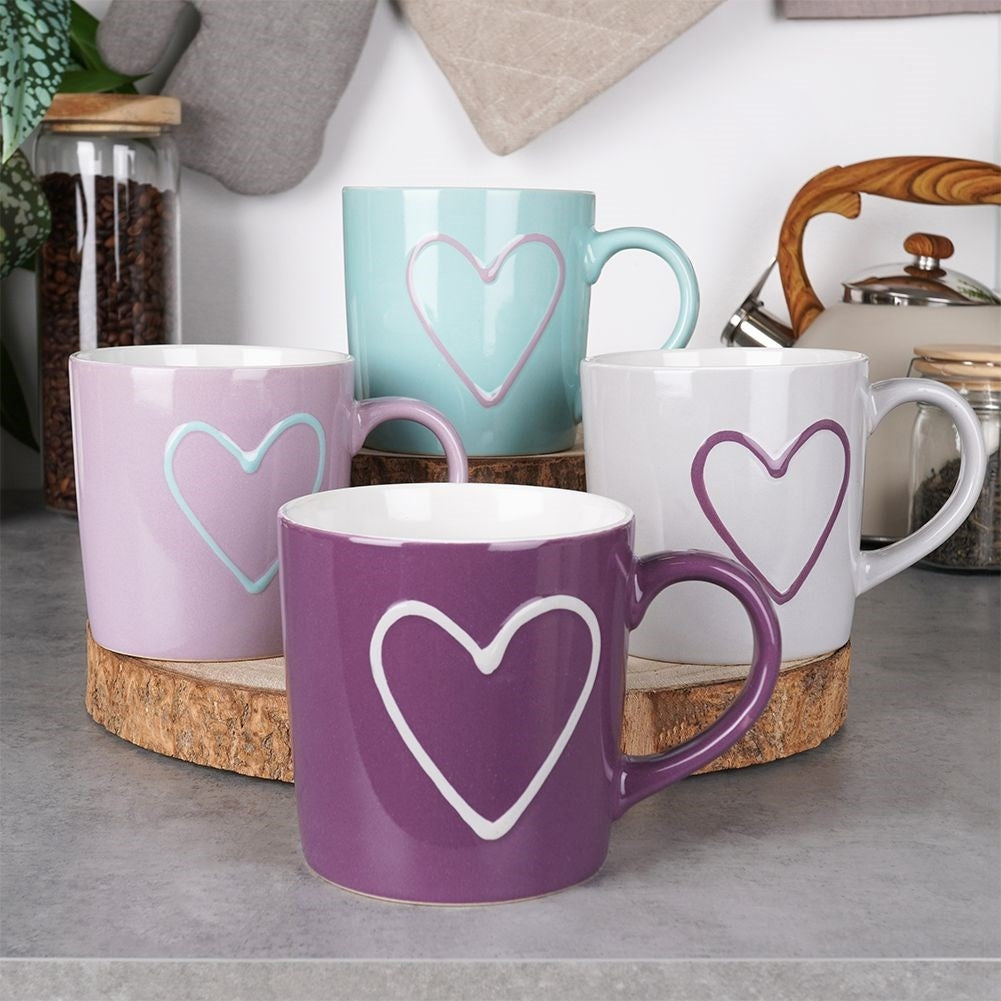 Colorful ceramic cups with heart motifs and comfortable handles