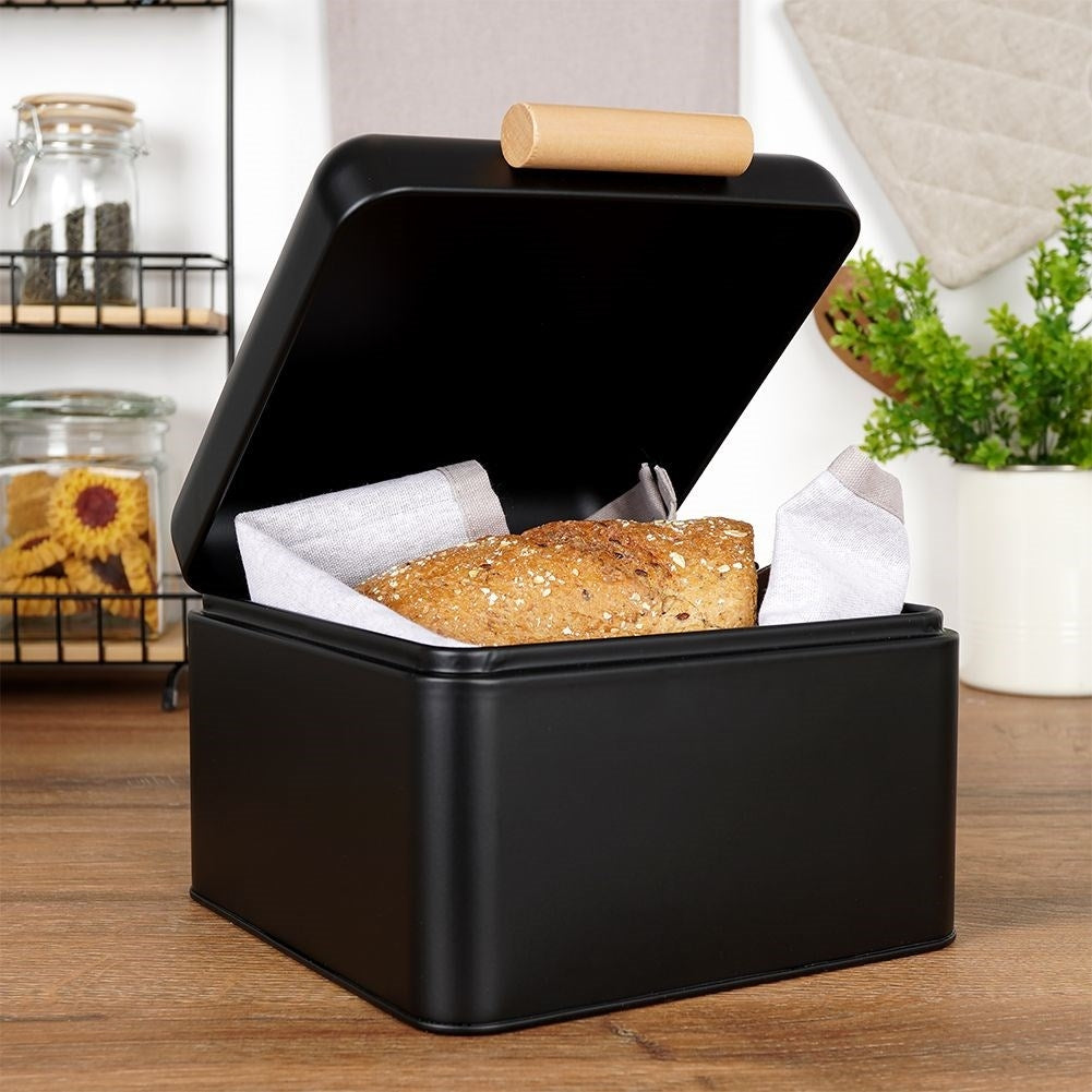 Compact black metal bread box with hinged lid