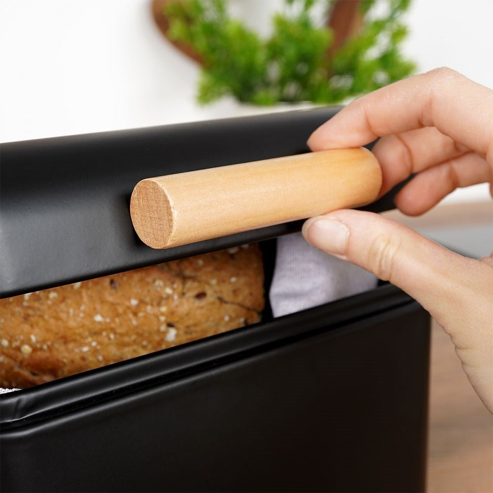 Compact black metal bread box with hinged lid