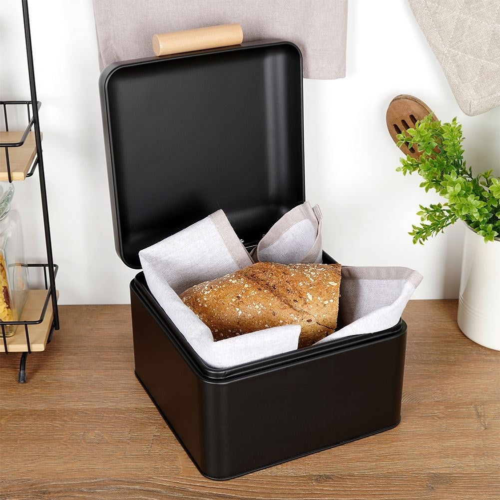 Compact black metal bread box with hinged lid