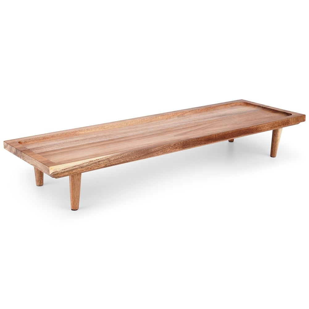 Cutting board made of acacia wood on high legs for serving