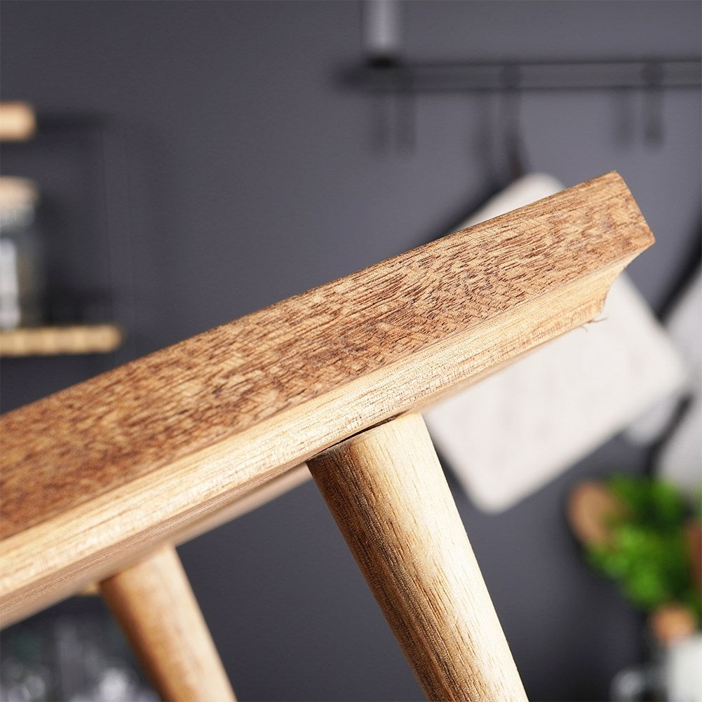 Cutting board made of acacia wood on high legs for serving