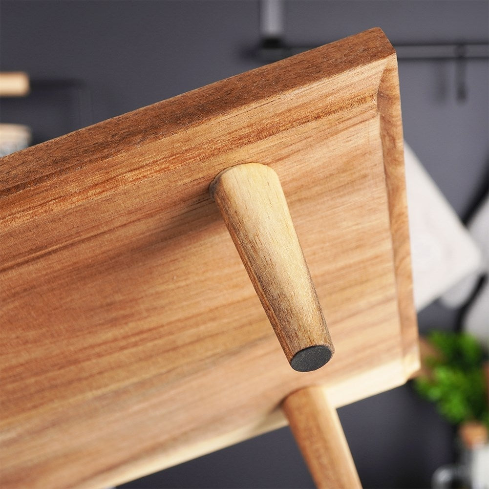 Cutting board made of acacia wood on high legs for serving