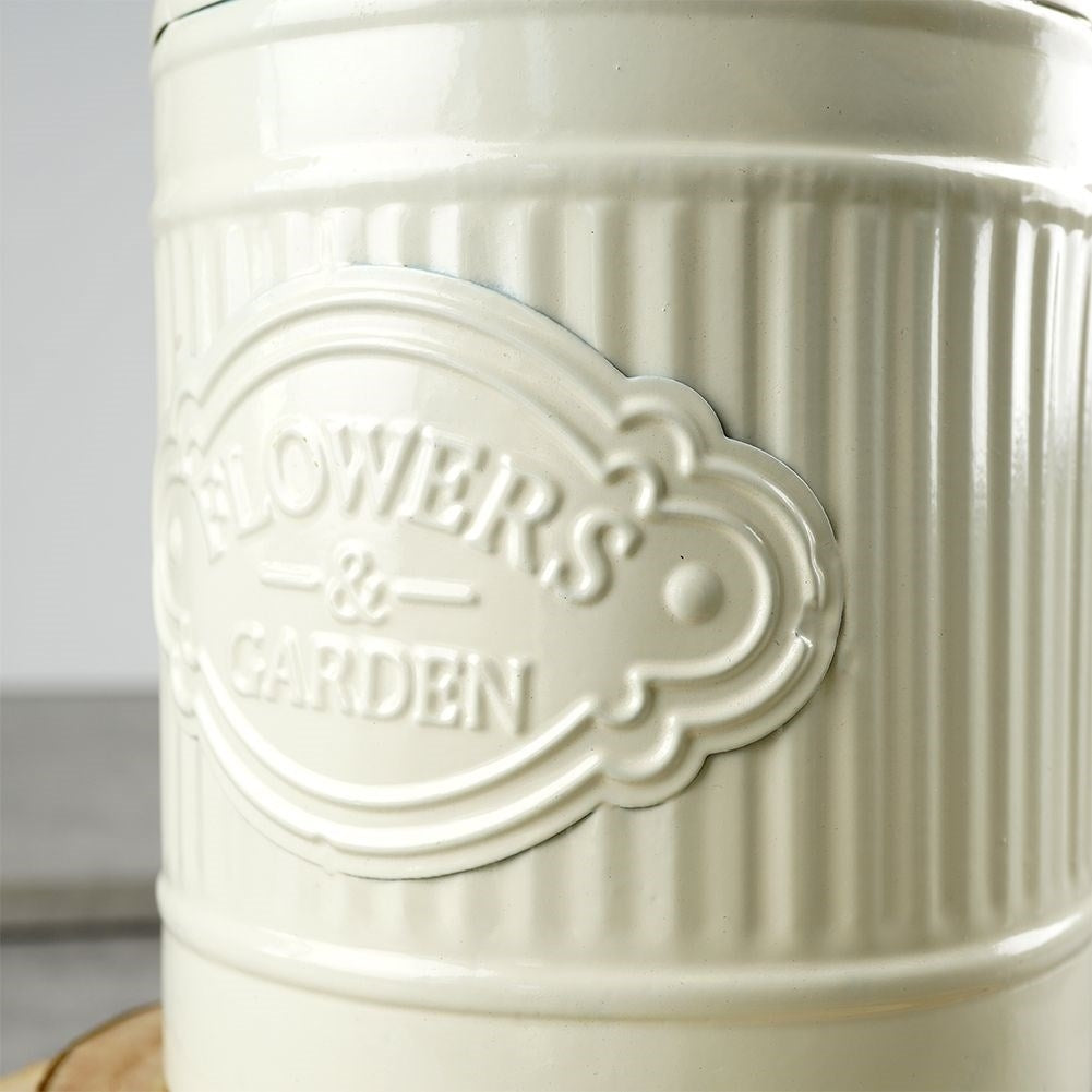 Decorative beige metal jug in retro style for home and garden