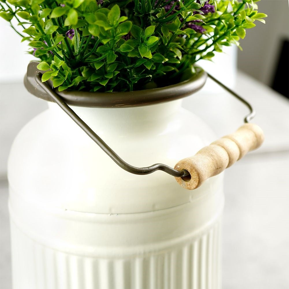 Decorative beige metal jug in retro style for home and garden