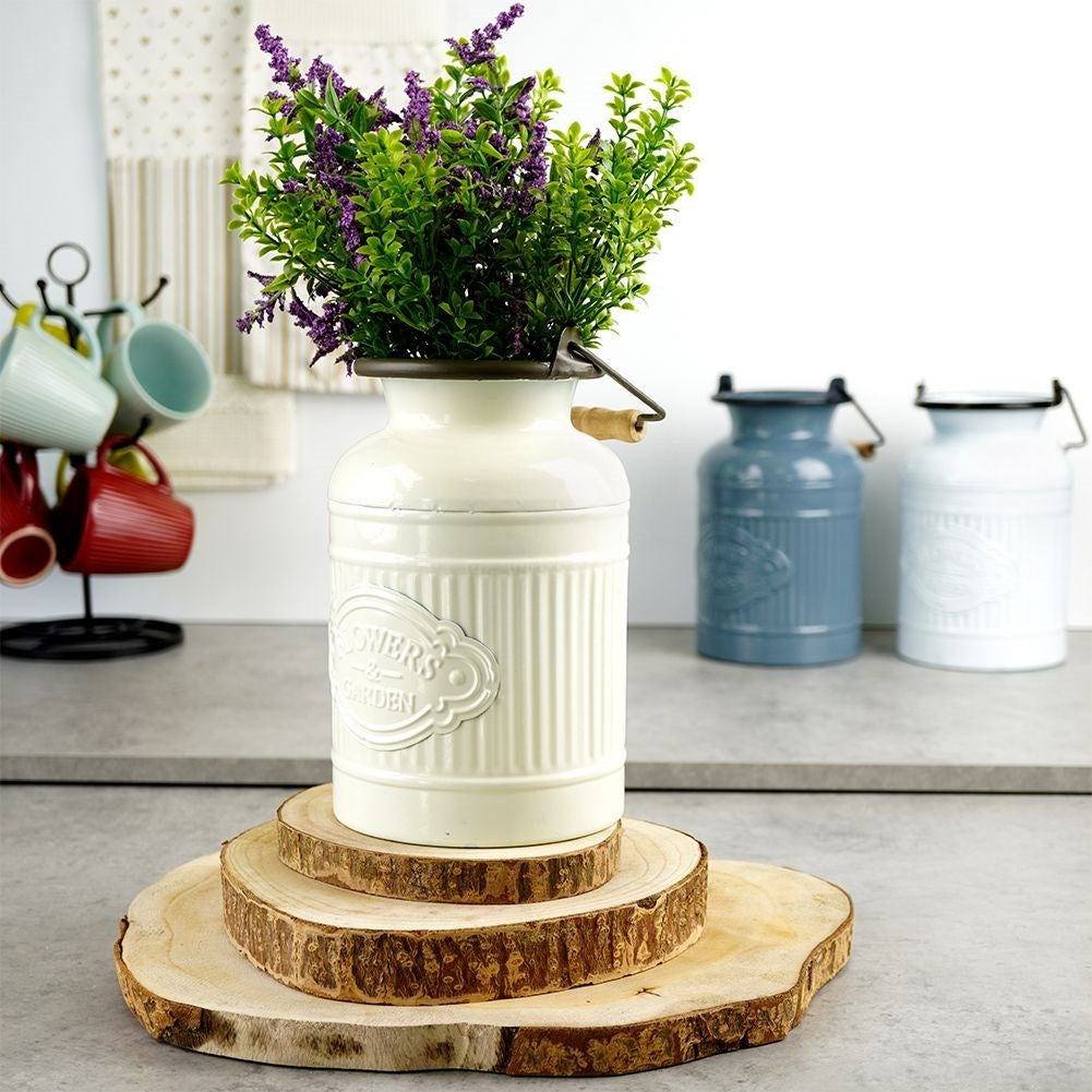 Decorative beige metal jug in retro style for home and garden