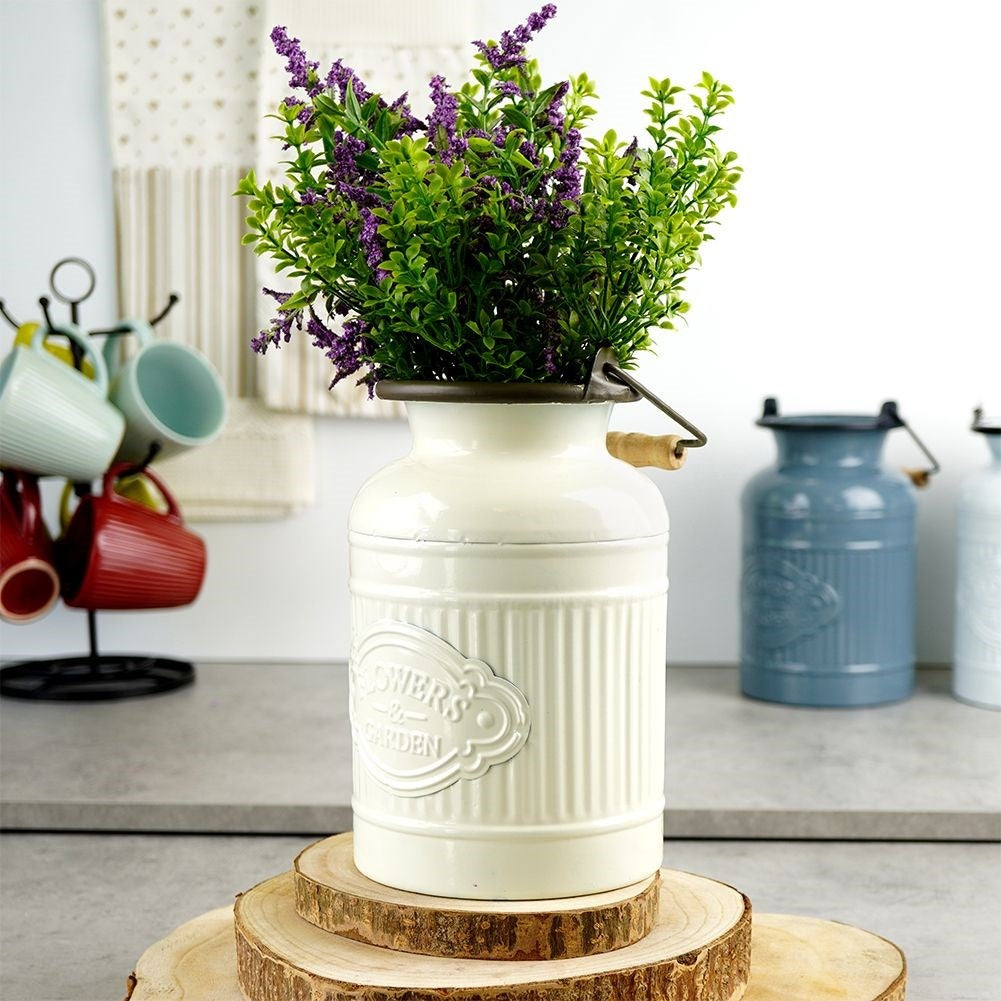 Decorative beige metal jug in retro style for home and garden