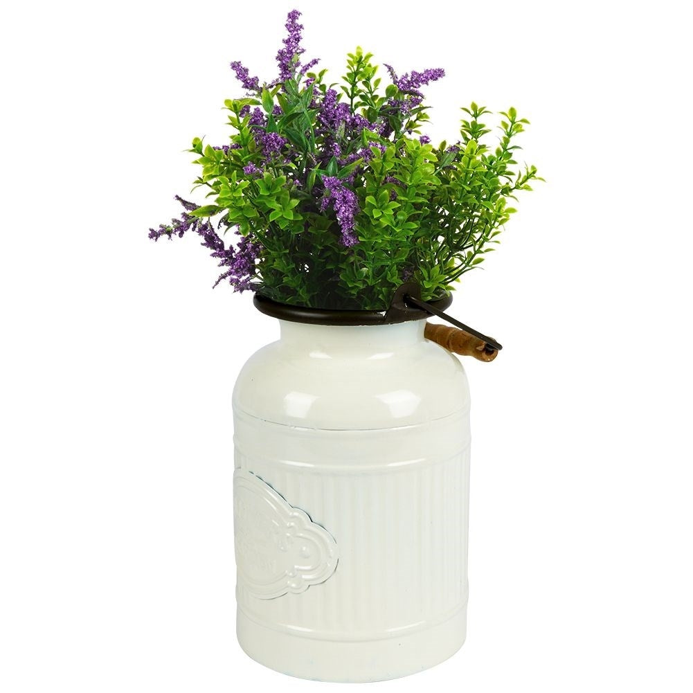 Decorative beige metal jug in retro style for home and garden