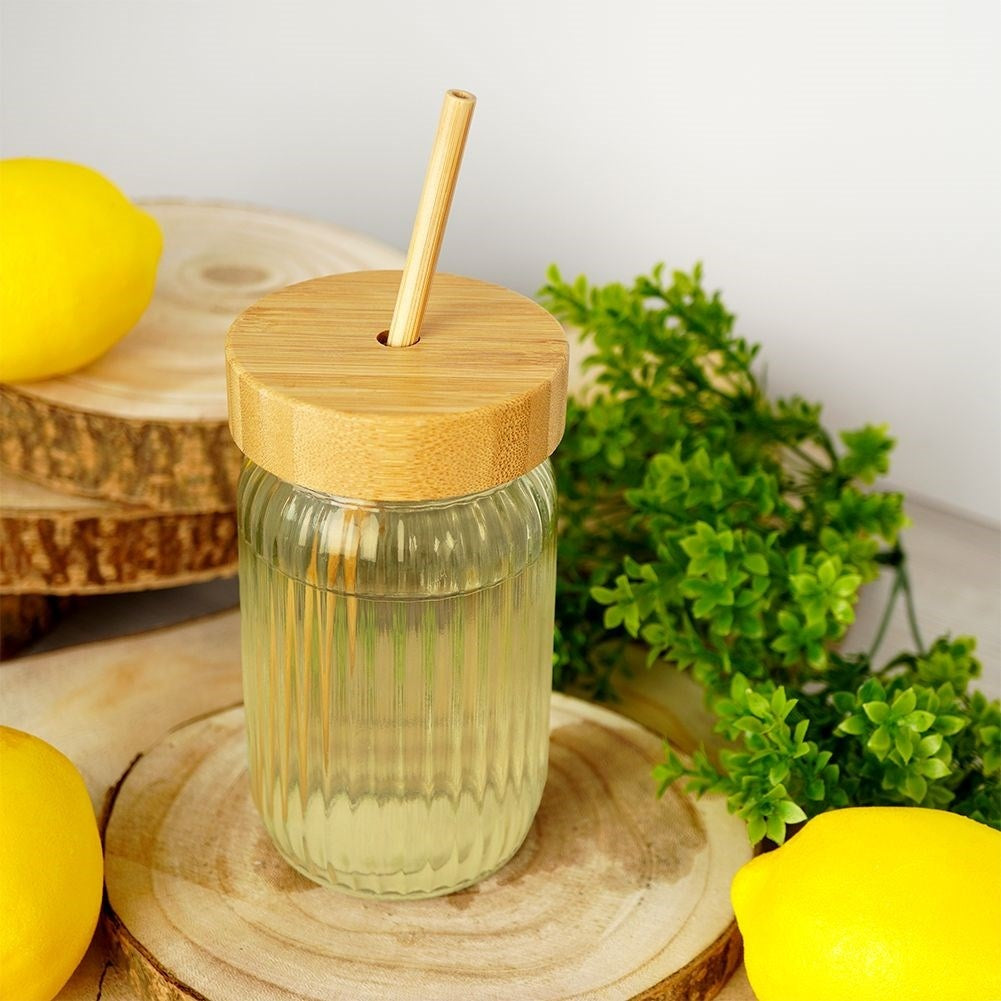 Drinking jar in thick glass with elegant stripes and bamboo straw