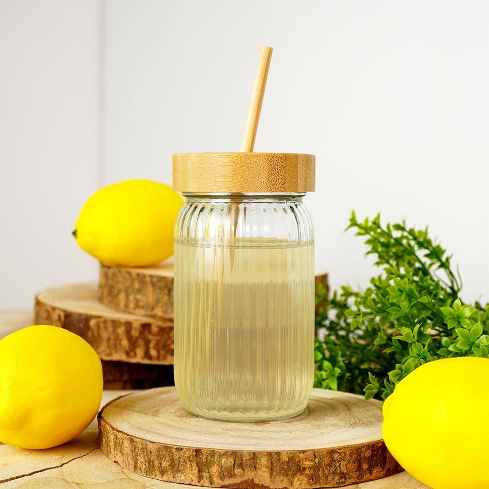 Drinking jar in thick glass with elegant stripes and bamboo straw