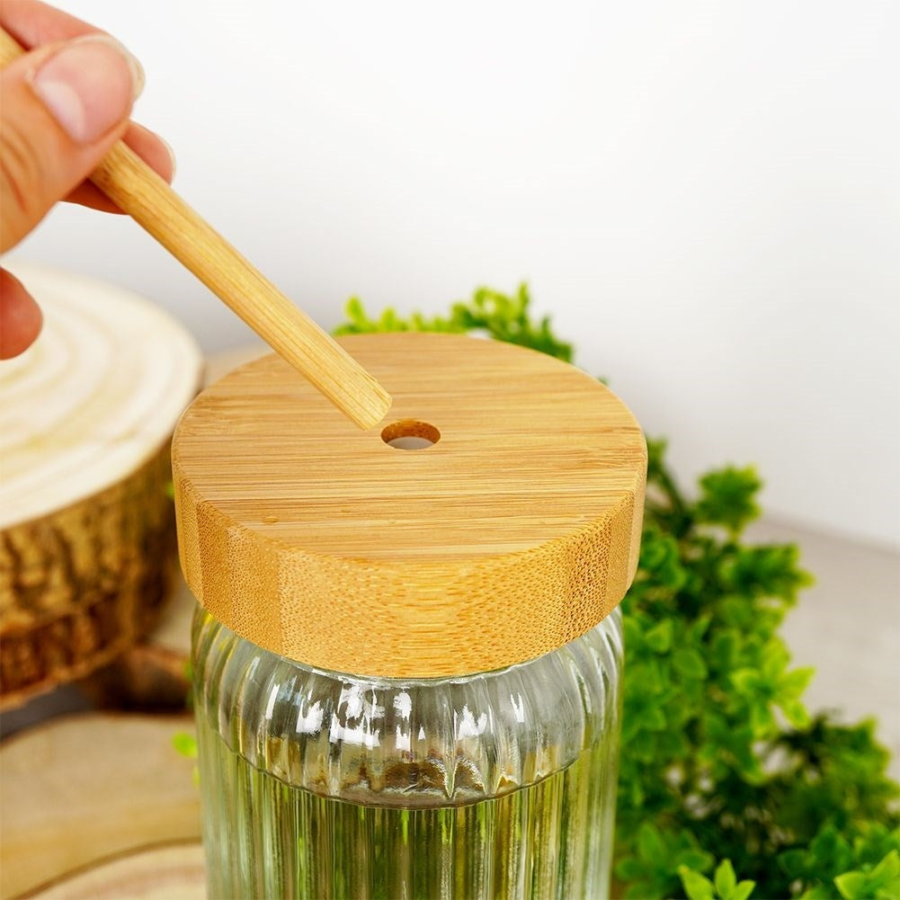 Drinking jar in thick glass with elegant stripes and bamboo straw