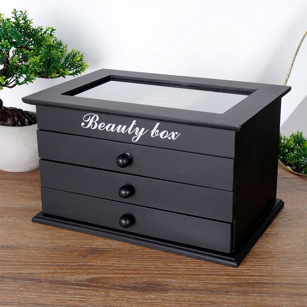 Elegant black jewelry box with glass lid and three drawers