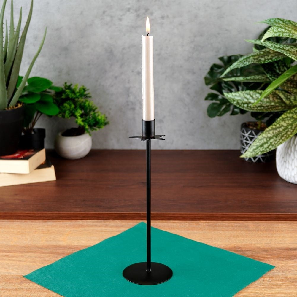 Elegant black metal candlestick with decorative star