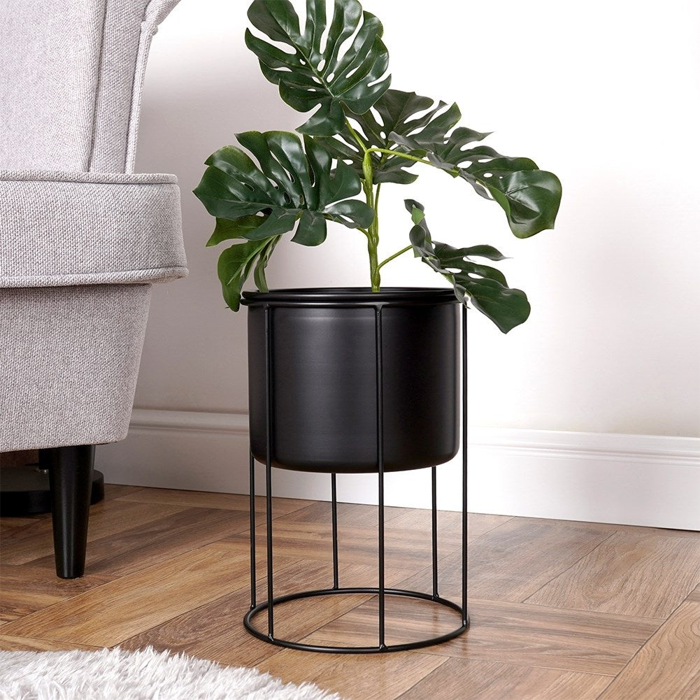 Elegant black metal pot on stand for plants
