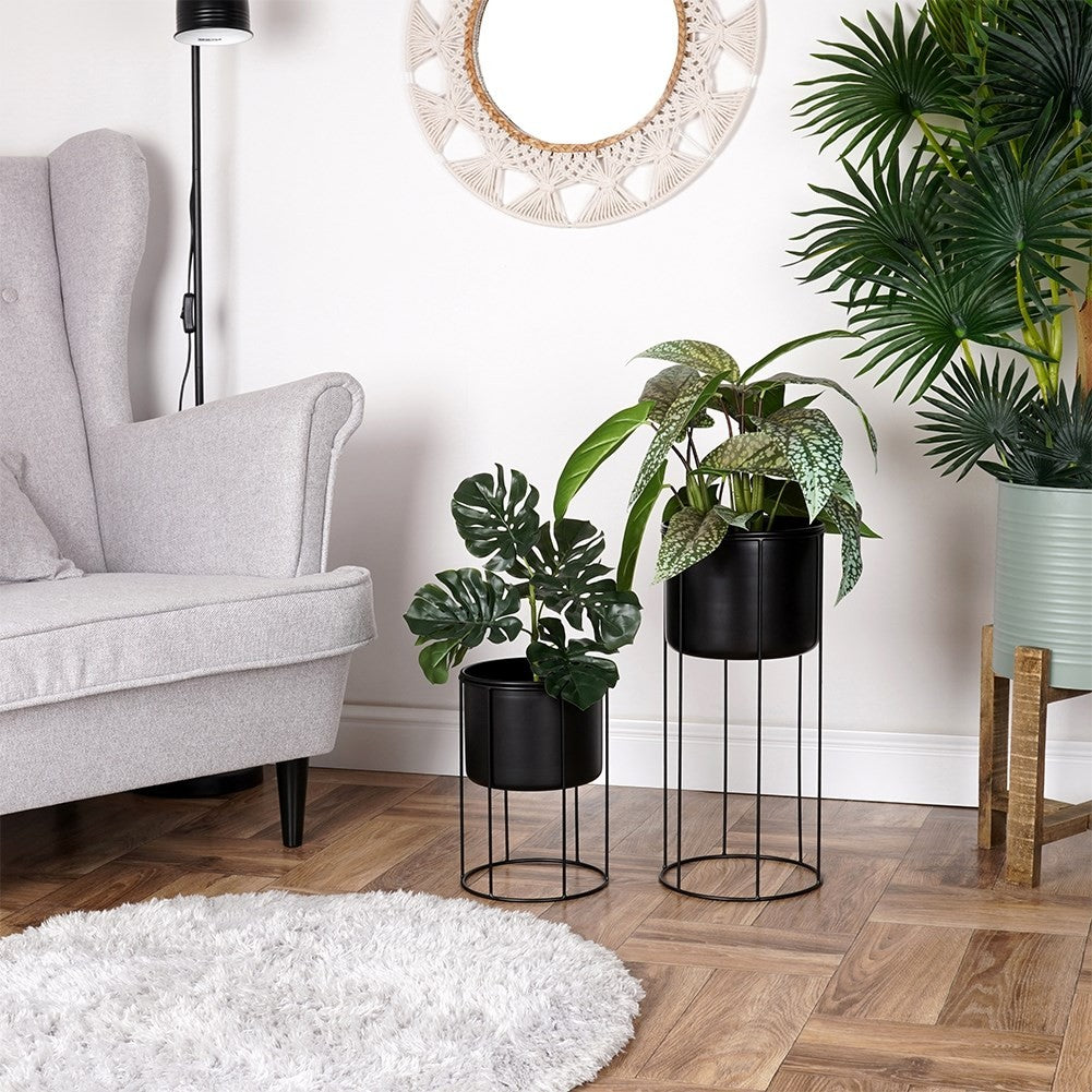 Elegant black metal pot on stand for plants