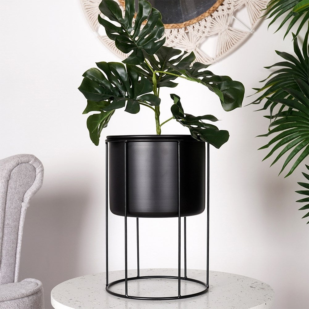 Elegant black metal pot on stand for plants