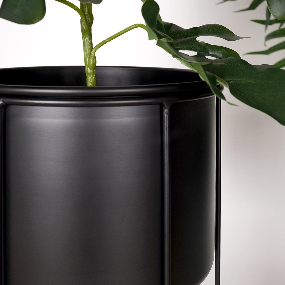 Elegant black metal pot on stand for plants