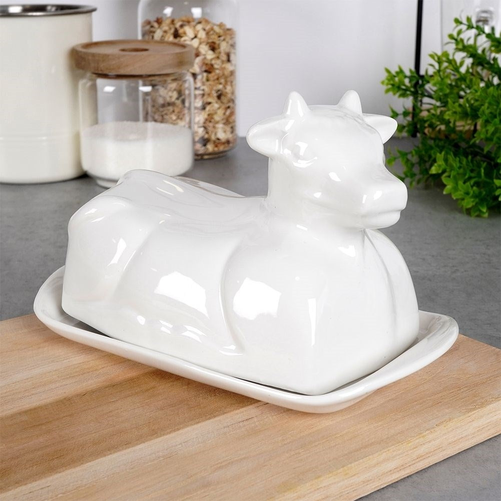 Elegant butter dish in the shape of a cow, white porcelain, with lid