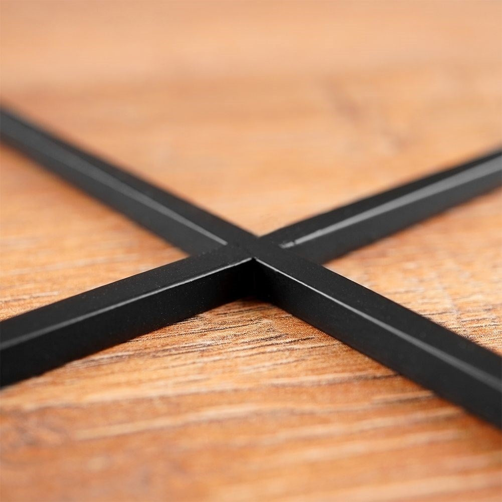 Elegant candle holder in black metal with four glass inserts