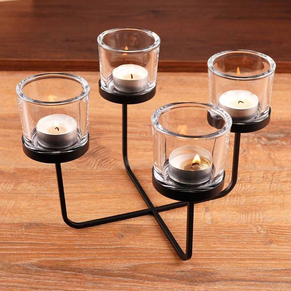 Elegant candle holder in black metal with four glass inserts