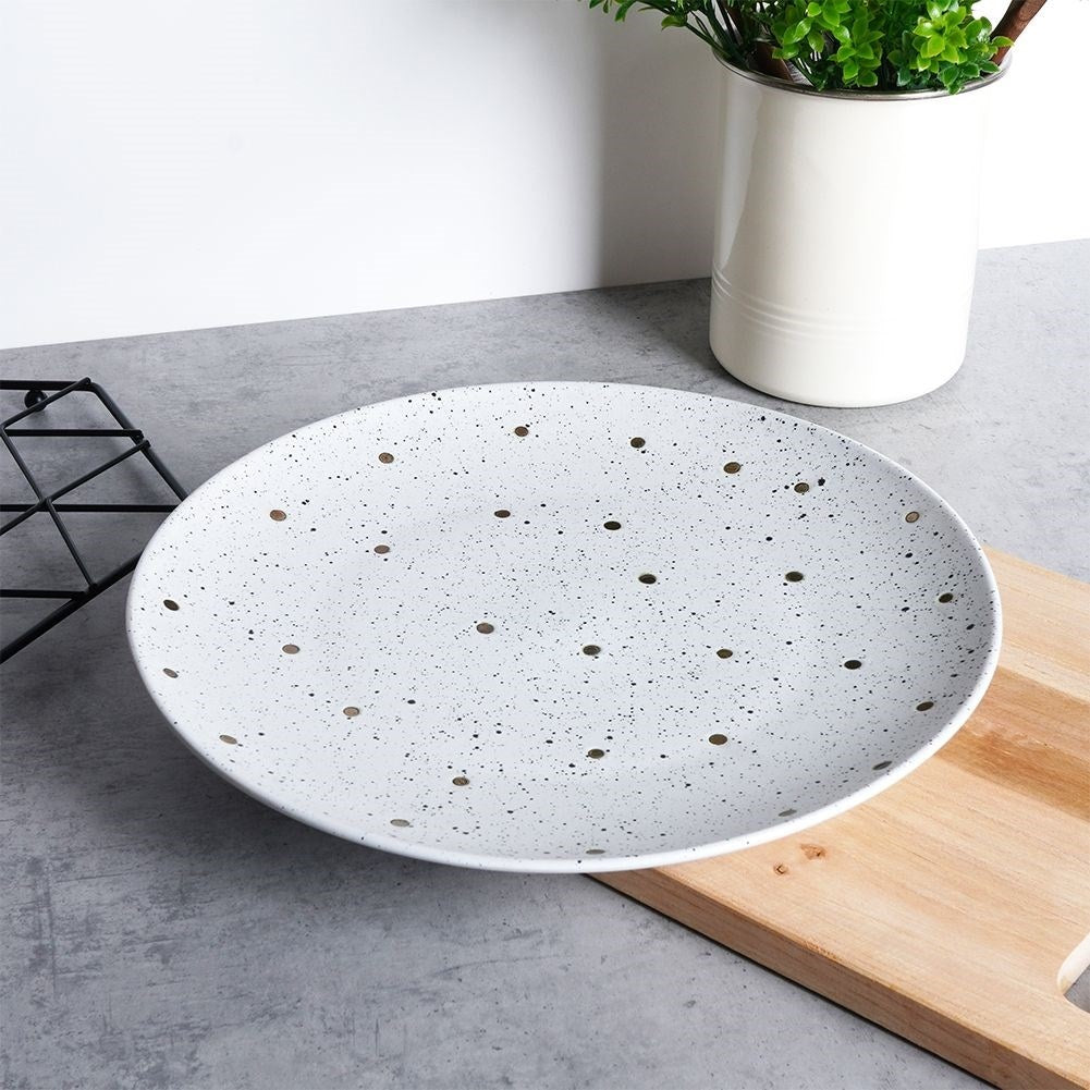 Elegant ceramic plate with black and gold dots