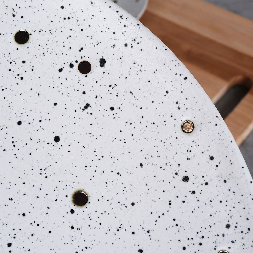 Elegant ceramic plate with black and gold dots
