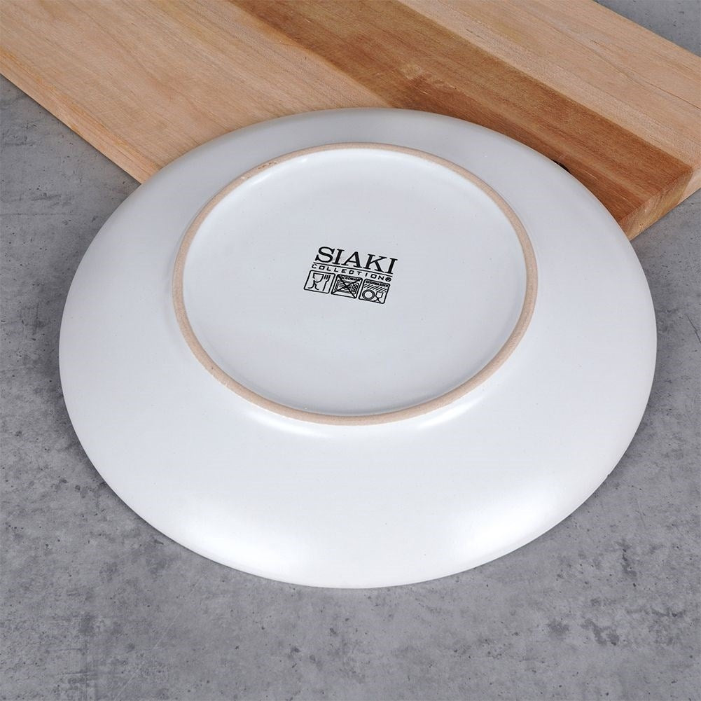 Elegant ceramic plate with black and gold dots