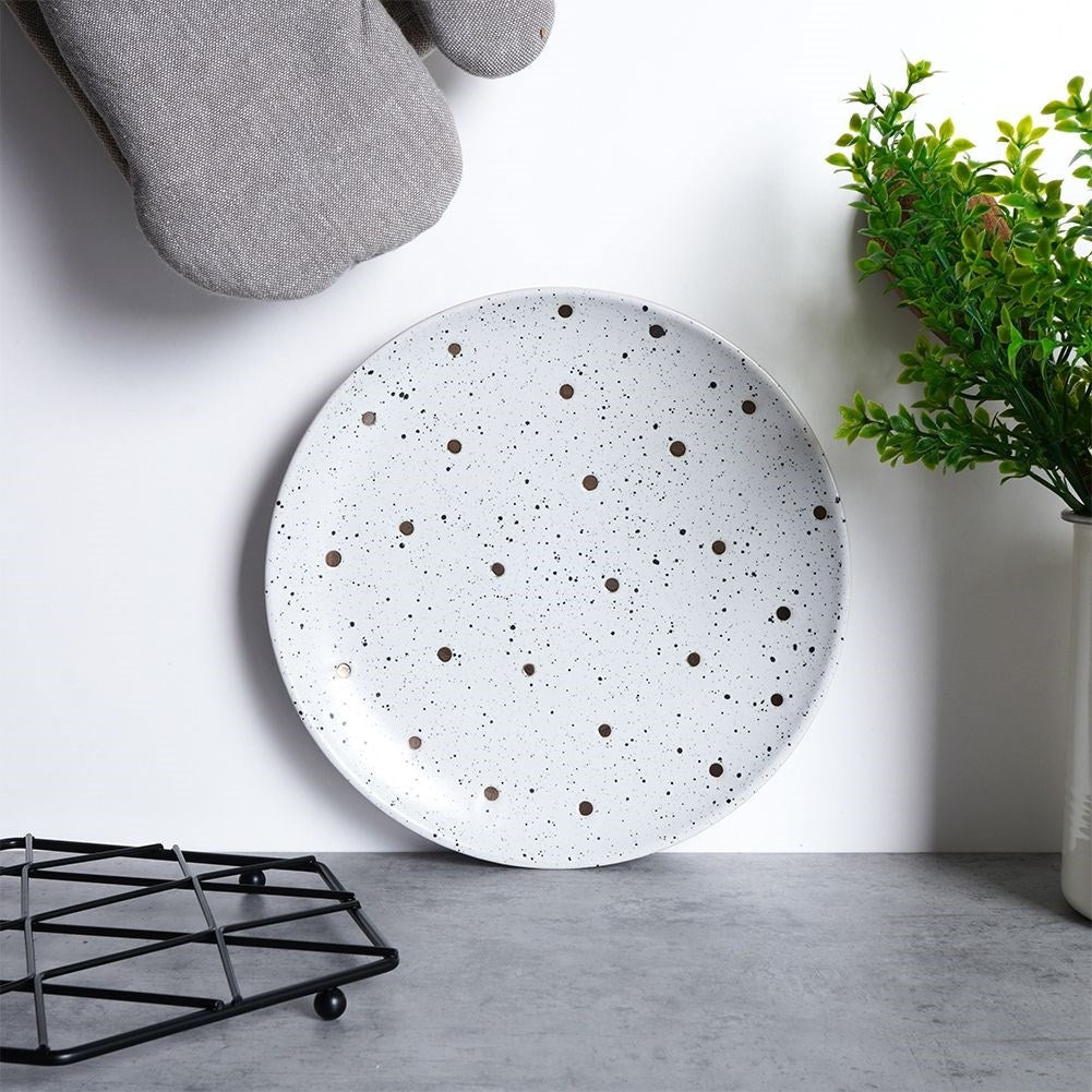 Elegant ceramic plate with black and gold dots