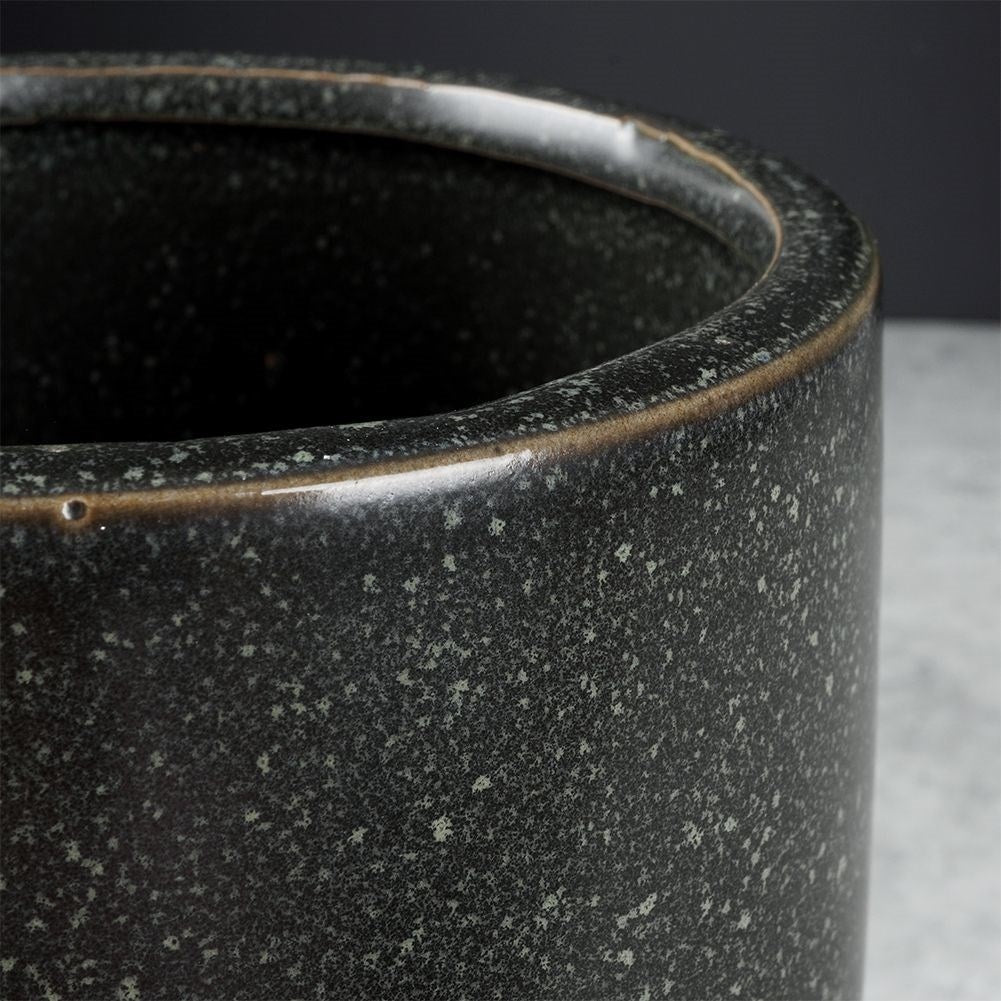 Elegant ceramic pot on legs with black, dotted pattern