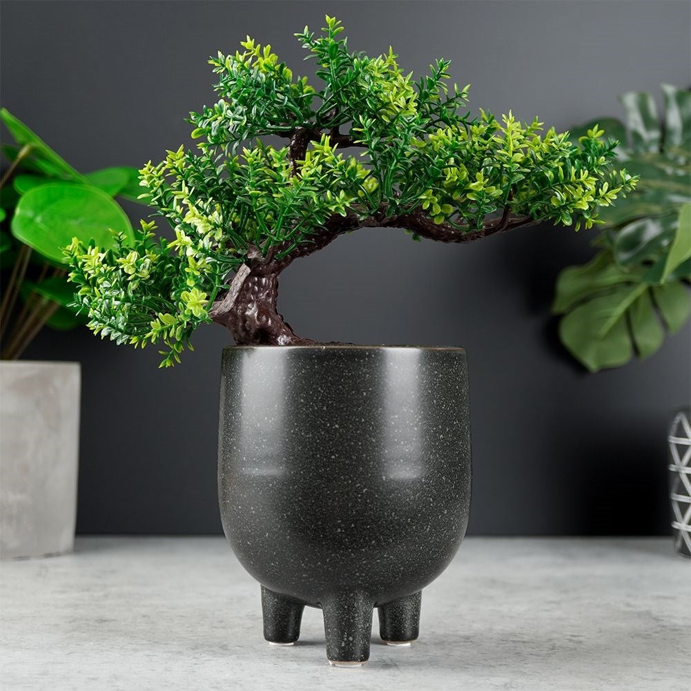 Elegant ceramic pot on legs with black, dotted pattern