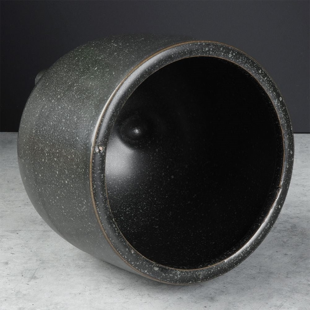 Elegant ceramic pot on legs with black, dotted pattern